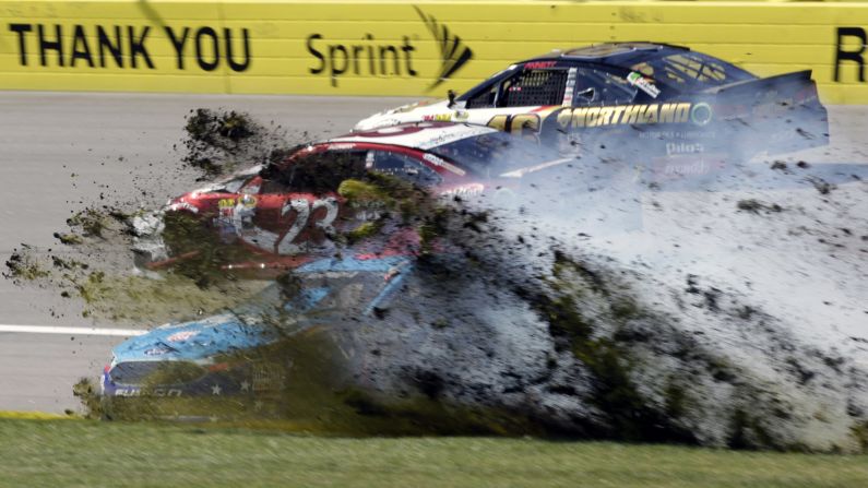 Aric Almirola's car plows through the infield at Kansas Speedway after colliding with David Ragan (No. 23) during a NASCAR Sprint Cup race on Sunday, October 16.