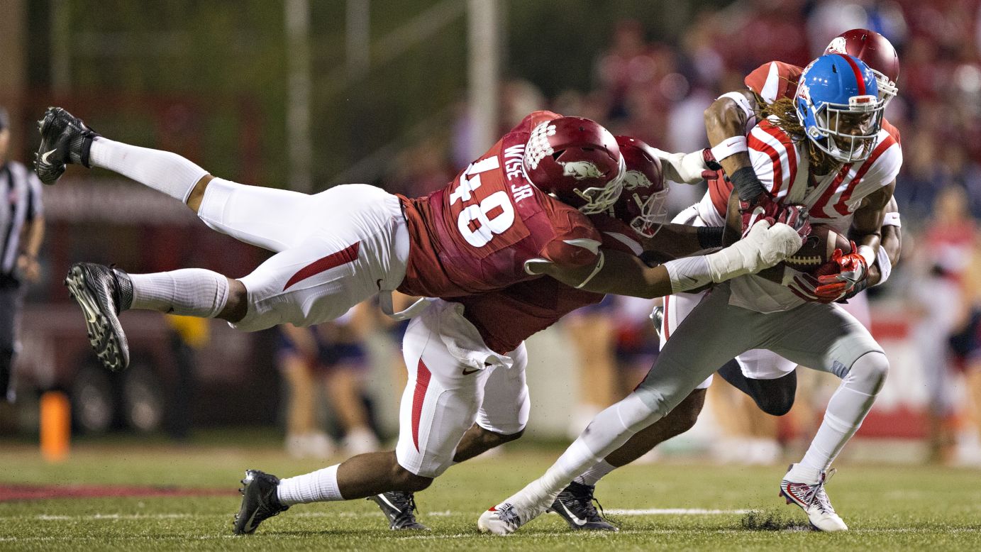 Ole Miss wide receiver Markell Pack is tackled by Arkansas defenders during a college football game in Fayetteville, Arkansas, on Saturday, October 15.