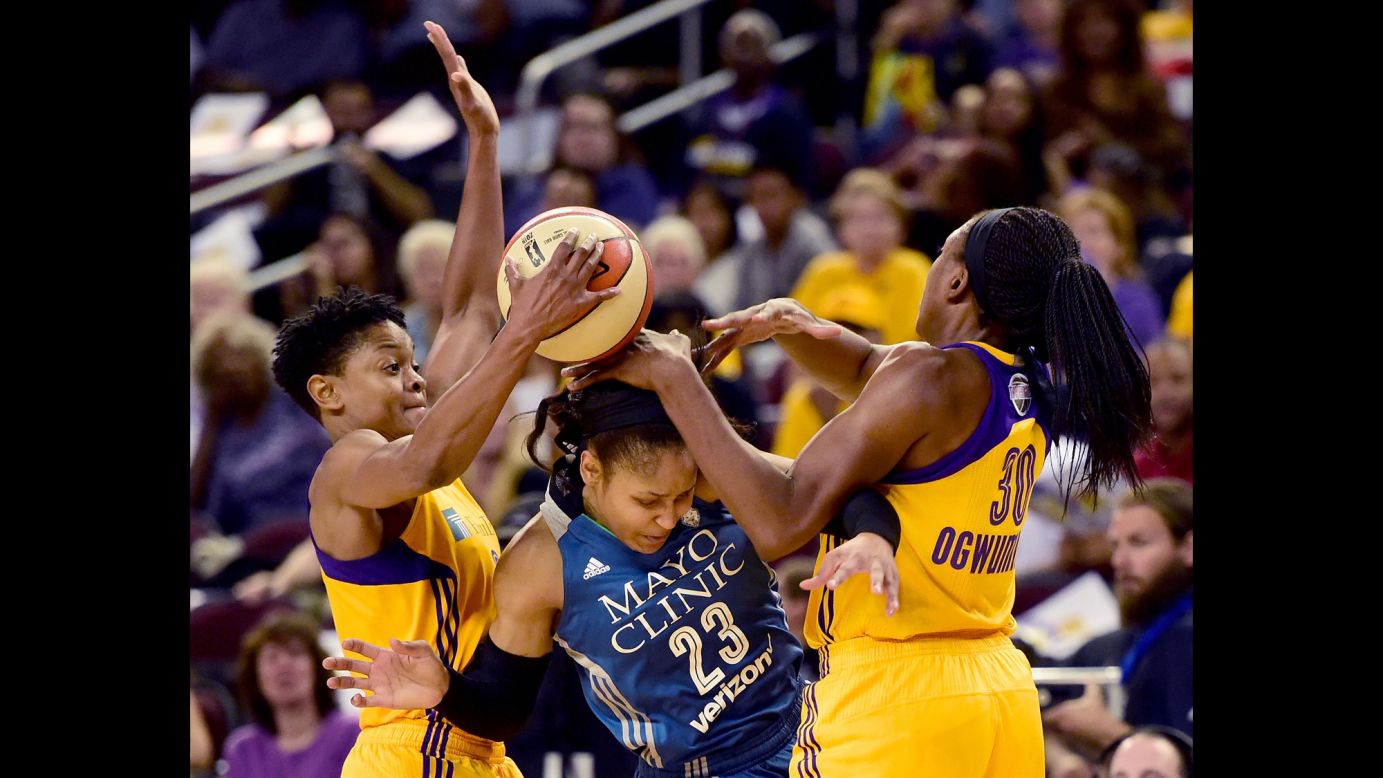 Minnesota forward Maya Moore is trapped by Los Angeles' Alana Beard, left, and Nneka Ogwumike during Game 3 of the WNBA Finals on Friday, October 14. The series is tied 2-2 going into the final game on Thursday.