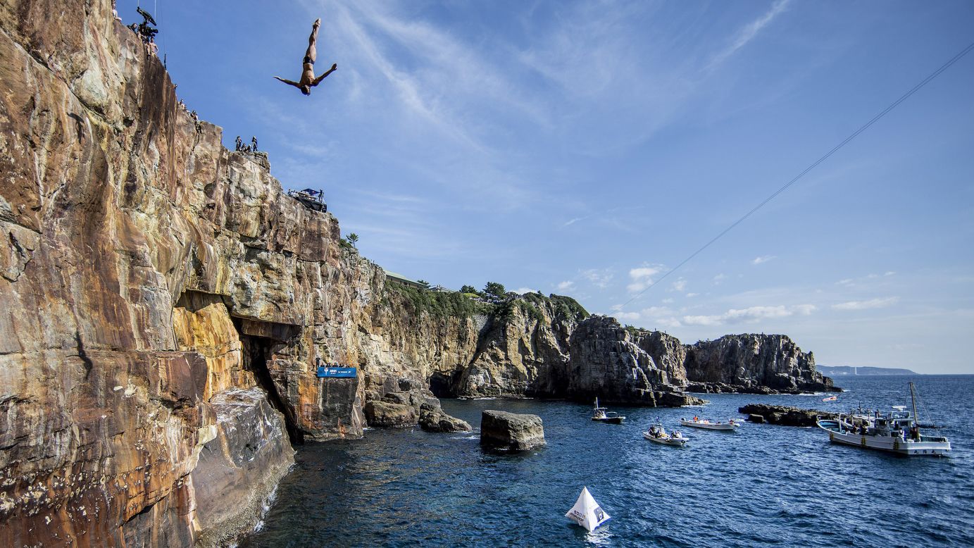 Jonathan Paredes dives off a cliff in Shirahima, Japan, on Saturday, October 15. It was the eighth stop of the Red Bull Cliff Diving World Series.