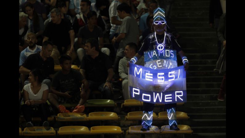 An Argentina fan holds a sign for superstar Lionel Messi before a World Cup qualifier against Paraguay on Tuesday, October 11.