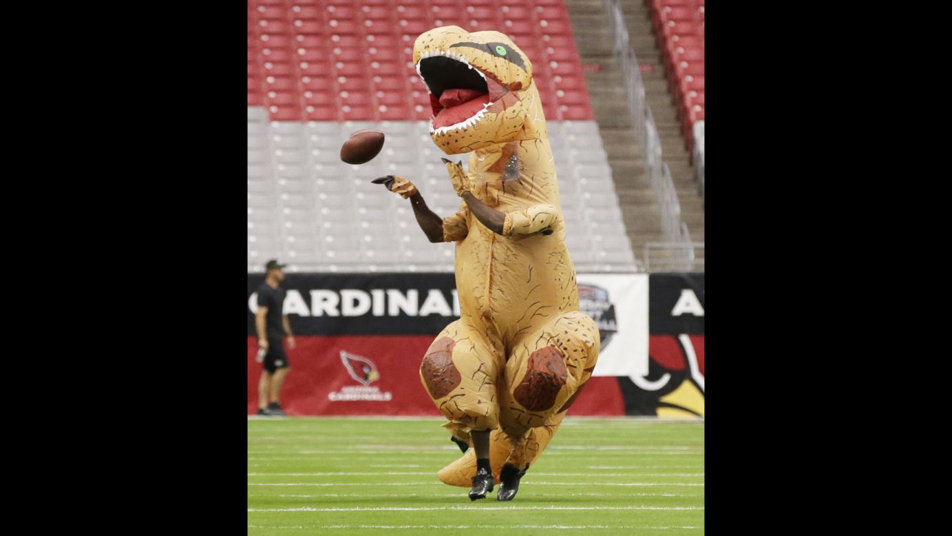 Arizona cornerback Patrick Peterson, dressed up as a dinosaur, warms up before an NFL game against the New York Jets on Monday, October 17. It was <a href="http://www.nfl.com/news/story/0ap3000000723066/article/patrick-peterson-preps-for-game-in-dinosaur-costume" target="_blank" target="_blank">his punishment</a> for losing a friendly throwing competition.