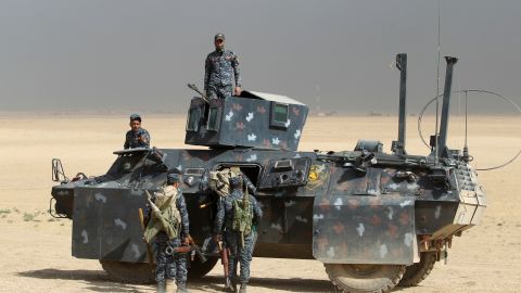 Iraqi forces hold a position on Monday in the area of al-Shurah, some 45 kilometers south of Mosul.