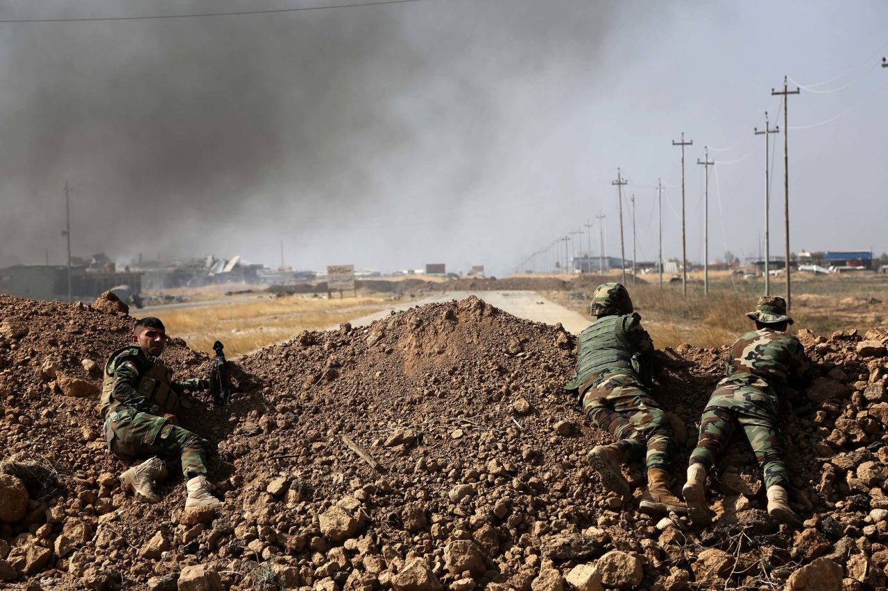 Kurdish security forces take up a position near ISIS-controlled villages on Monday, October 17.