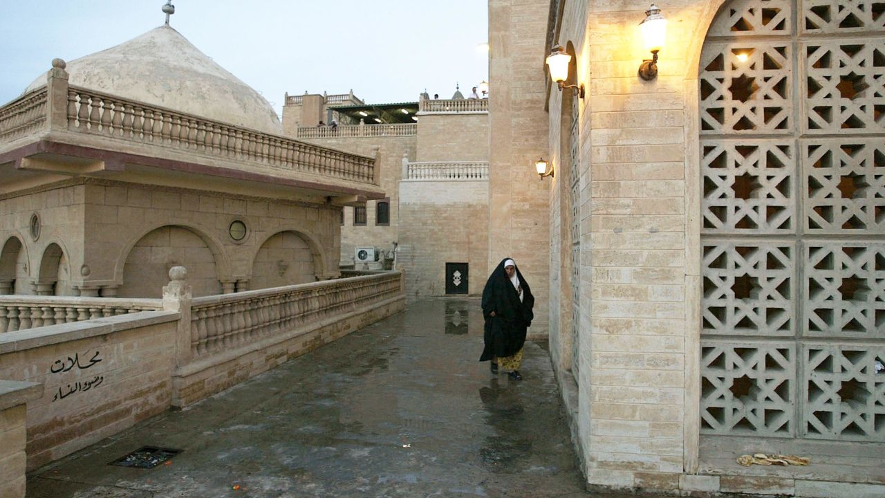 An Iraqi woman walks near the mosque of the Prophet Usuf in October 2002.