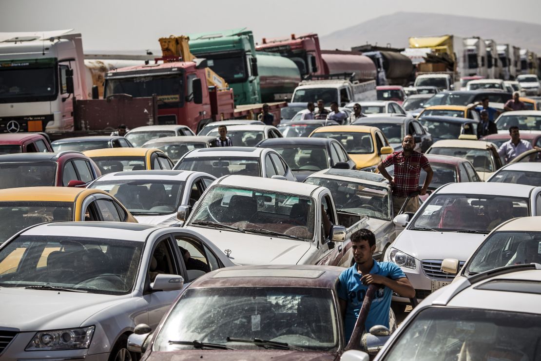 Traffic from Mosul queues at a Kurdish check point on June 14, 2014 in Kalak, Iraq.