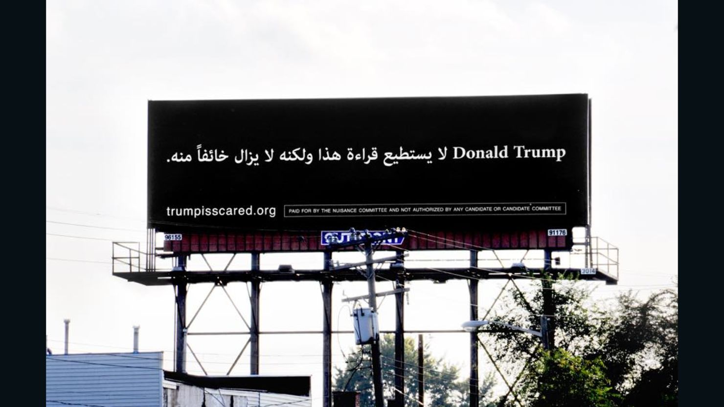 A billboard in Dearborn, Michigan, reads "Donald Trump can't read this, but he's afraid of it anyway" in Arabic.