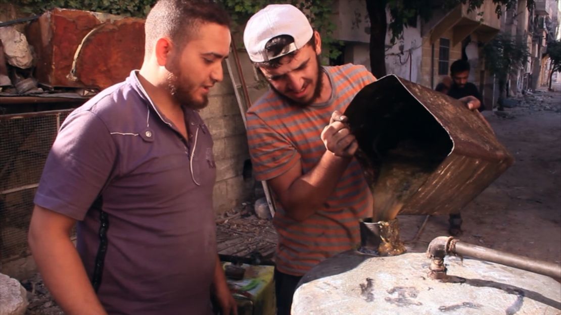 An eastern Aleppo man makes fuel from heated plastic. Residents say one kilogram of plastic can make a liter of fuel.