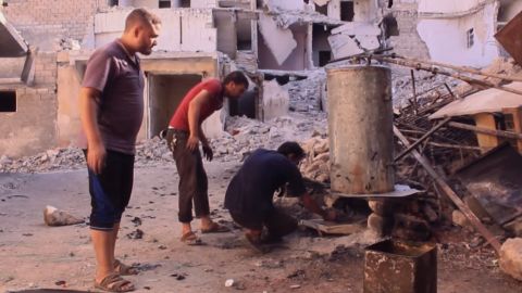 Aleppo residents use an old boiler to make fuel out of plastic.
