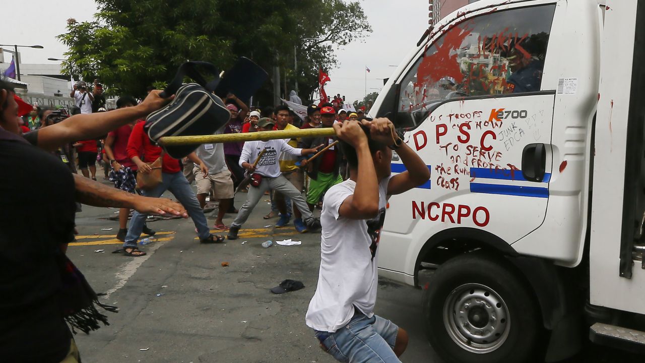 Protesters hit a Philippine National Police van after it rammed into protesters.