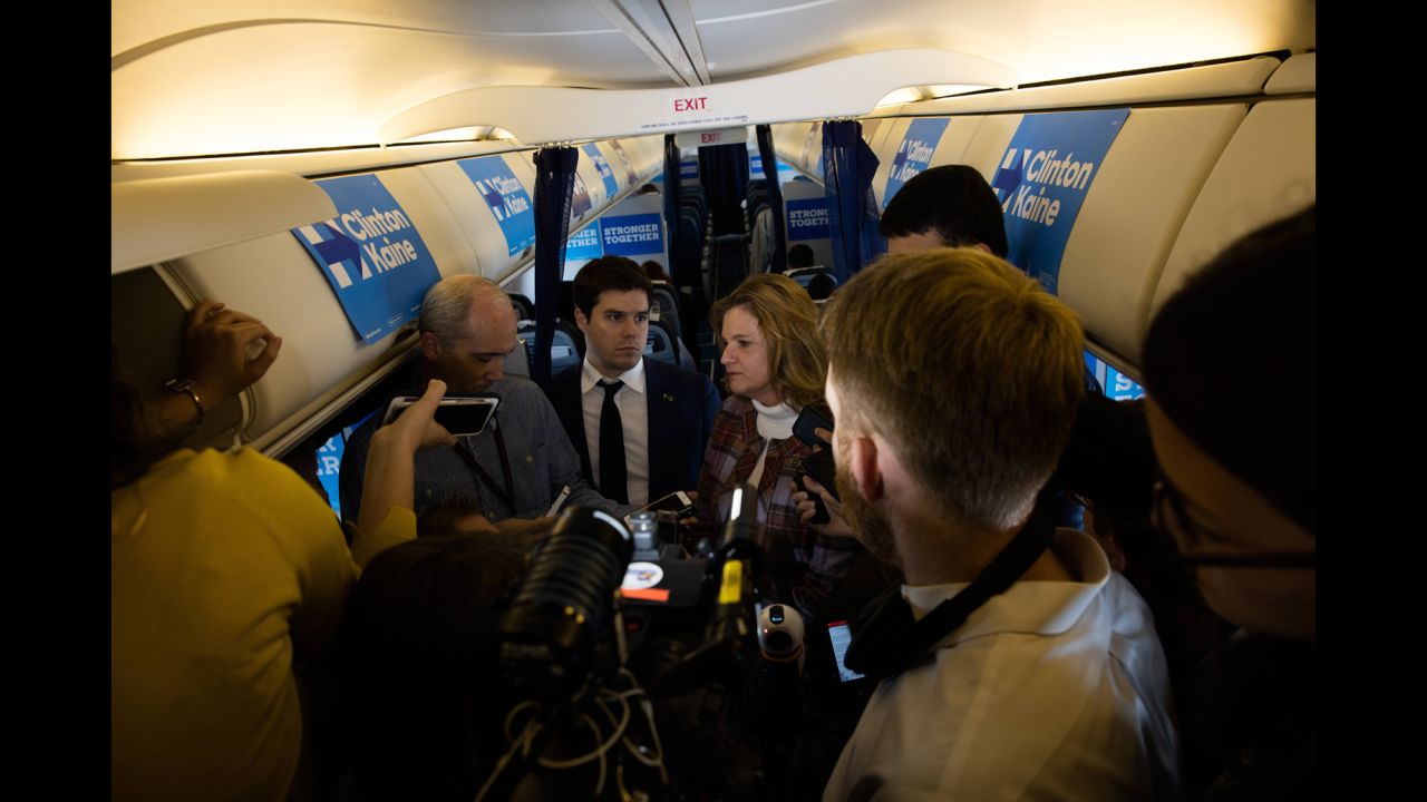 Clinton's campaign staff takes questions from the media on her plane in Seattle on October 14.