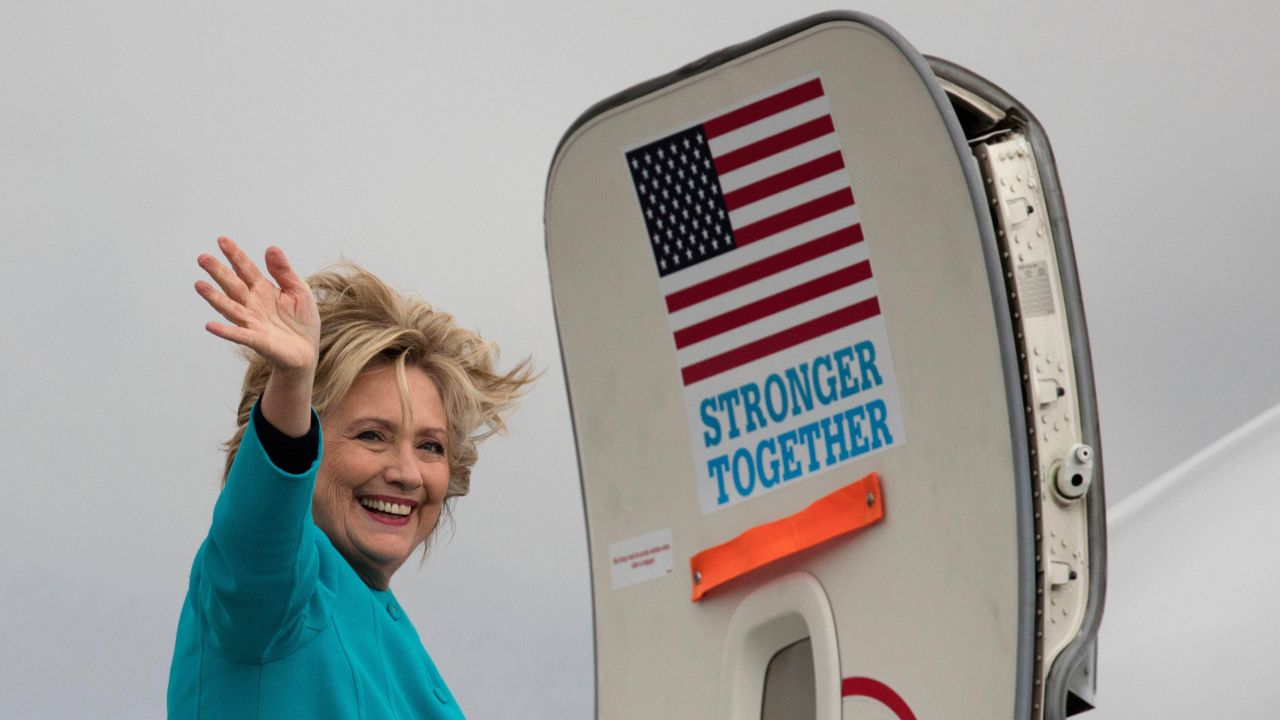 Clinton waves as she boards her campaign plane in Seattle on Friday, October 14.