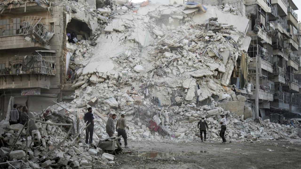 Members of the White Helmets rescue group search for victims after an airstrike on Aleppo on October 17.