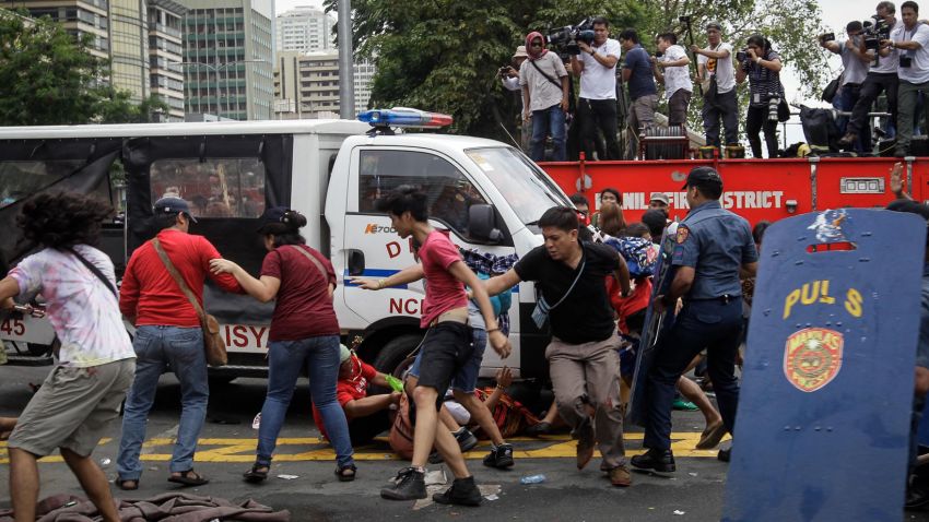 epa05591541 A police mobile runs over protesters during a protest in front of the US Embassy in Manila, Philippines, 19 October 2016. Hundreds of protesters including Indigenous People, students and militant groups stormed toward the US Embassy to protest against the presence of US military troops and to support Philippine President Rodrigo Duterte's independent foreign policy pronouncements. The protest ended violently as the protesters clashed with the police during the dispersal. Initial reports said at least five protesters and around thirty police officers were hurt.  EPA/MARK R. CRISTINO