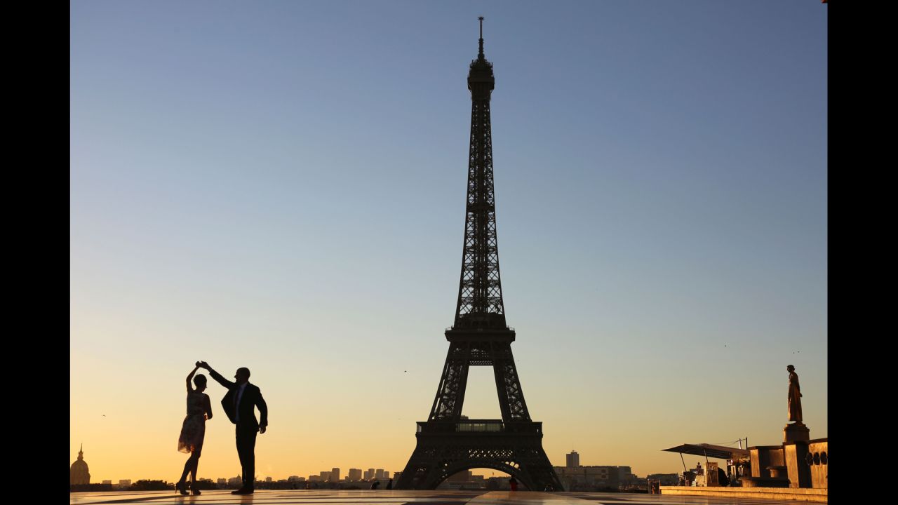 A couple dance at sunrise on Trocadero Plaza in front of the Eiffel tower. The tower celebrated its 127th anniversary in 2016. 