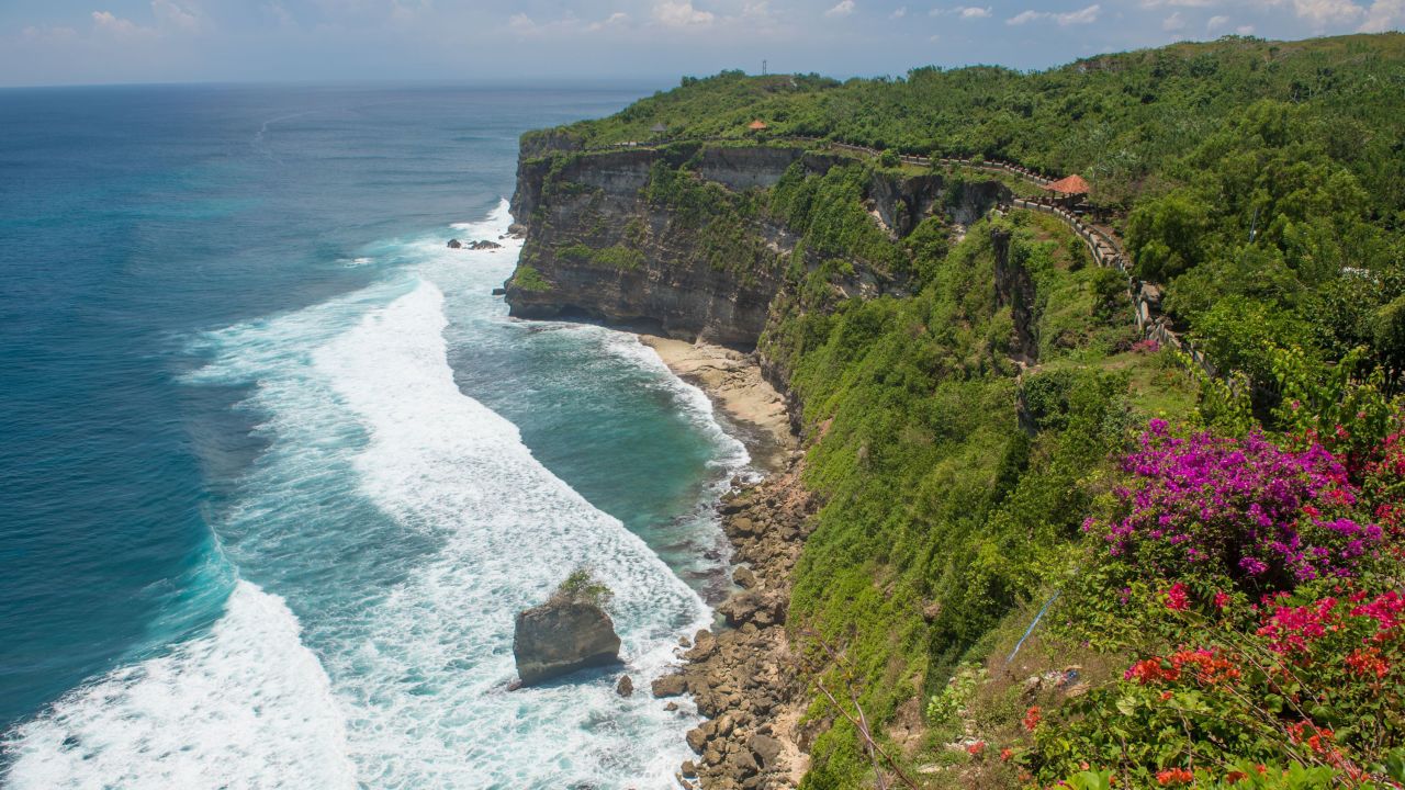 Uluwatu beach in Bali is one of the world's top surf destinations. The nearby temple Pura Luhur Ulu Watu, perched on cliffs on the southwest peninsula, is also a popular attraction. 