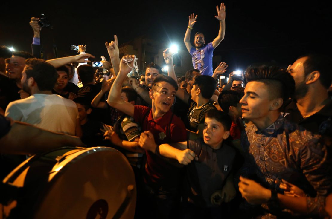 Displaced Christians from Qaraqosh celebrate in Irbil as Iraqi forces move in to free their hometown. 