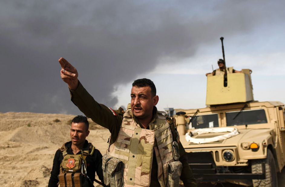 Iraqi forces head toward the front lines near Qayyara on Tuesday, October 18.