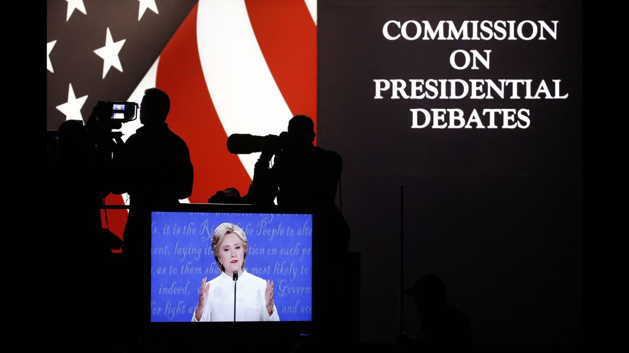 Clinton is seen on a television screen at the debate venue.