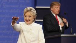 Democratic presidential nominee Hillary Clinton waves to the audience as Republican presidential nominee Donald Trump puts away his notes after the third presidential debate at UNLV in Las Vegas, Wednesday, Oct. 19, 2016. (AP Photo/John Locher)