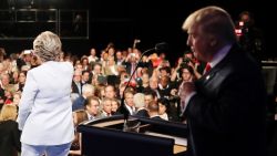 Democratic presidential nominee former Secretary of State Hillary Clinton gestures to the crowd as she walks off stage as Republican presidential nominee Donald Trump looks on after the third U.S. presidential debate at the Thomas & Mack Center on October 19, 2016 in Las Vegas, Nevada.