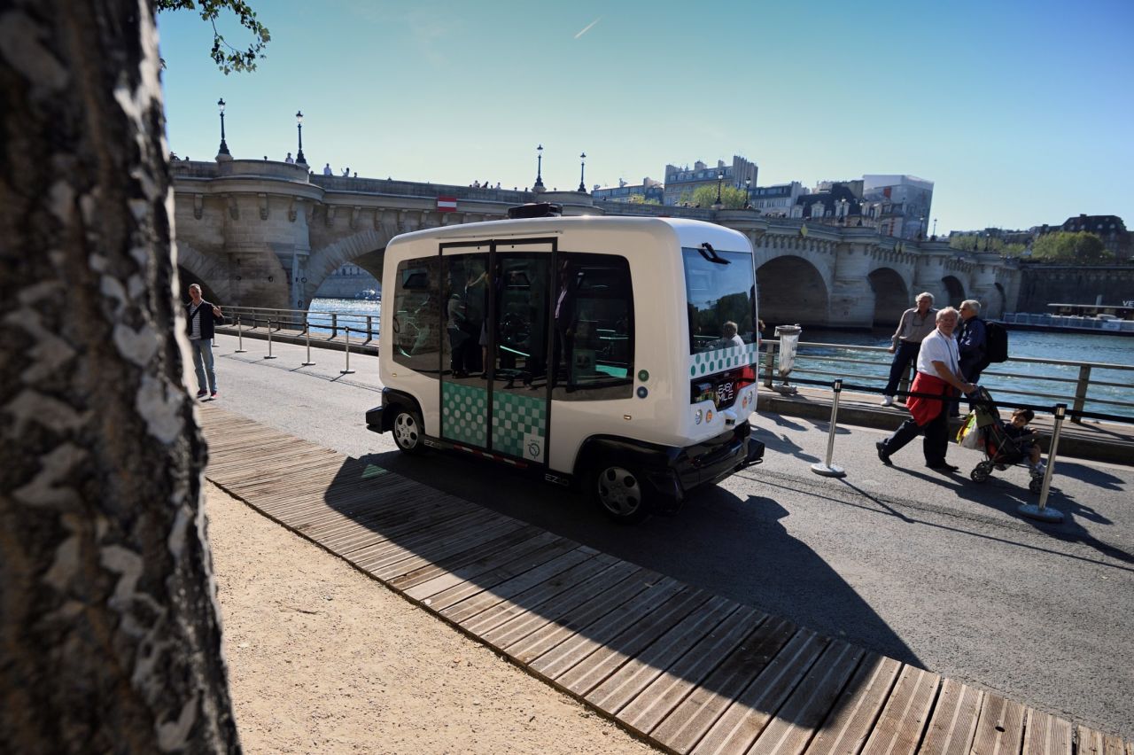 An electric-powered driverless EZ10 minibus, seen in Paris, 2016. Developed by French firm Easymile and Dubai-based Omnix International, the bus -- known as "The Smart Autonomous Vehicle" in Dubai -- drives along pre-programmed routes and features 360-degree sensors to monitor and react to its surrounds.<br />