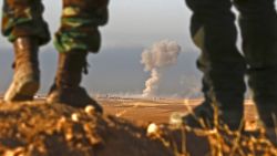 TOPSHOT - Iraqi Kurdish Peshmerga fighters stand in an area near the town of Bashiqa, some 25 kilometres north east of Mosul, as smoke billows on October 20, 2016, during an operation against Islamic State (IS) group jihadists to retake the main hub city.
Kurdish forces launched a fresh push against areas held by the Islamic State group around Mosul, pressing an offensive to retake the jihadists' last major stronghold in Iraq. / AFP / SAFIN HAMED        (Photo credit should read SAFIN HAMED/AFP/Getty Images) 