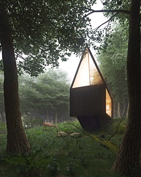 With an exterior built of dark angled planes, this secluded cabin provides natural light through ceiling-to-floor windows and a skylight. 