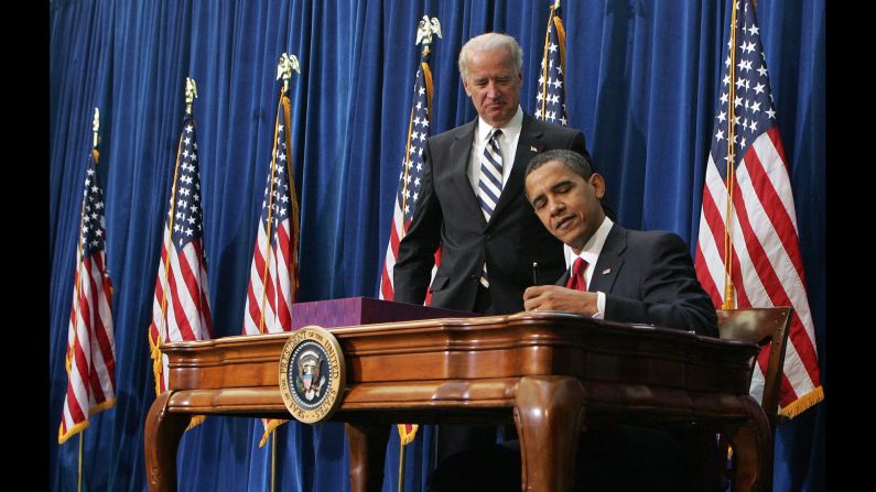 Vice President Joe Biden watches Obama sign <a href="index.php?page=&url=http%3A%2F%2Fwww.cnn.com%2F2010%2FPOLITICS%2F02%2F17%2Feconomic.stimulus.2010%2F" target="_blank">the economic stimulus bill</a> on February 17, 2009. The goal was to stimulate the country's staggering economy by increasing federal spending and cutting taxes.