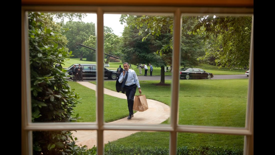 The President returns to the Oval Office after going on a hamburger run for West Wing staffers and aides on May 29, 2009.