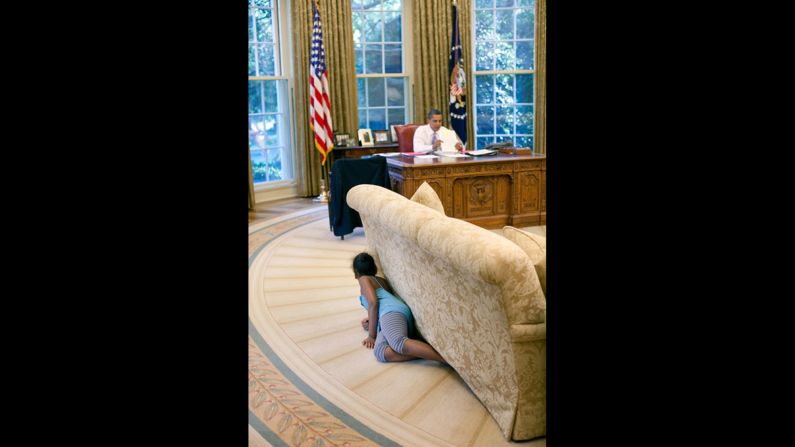 Sasha Obama hides behind an Oval Office sofa as she sneaks up on her father on August 5, 2009. Sasha was 7 when her father took office. Malia was 10. <a href="index.php?page=&url=http%3A%2F%2Fwww.cnn.com%2F2012%2F09%2F05%2Fpolitics%2Fgallery%2Fsasha-and-malia-2008-present%2Findex.html" target="_blank">See more pictures of Malia and Sasha Obama since their father was elected President</a>