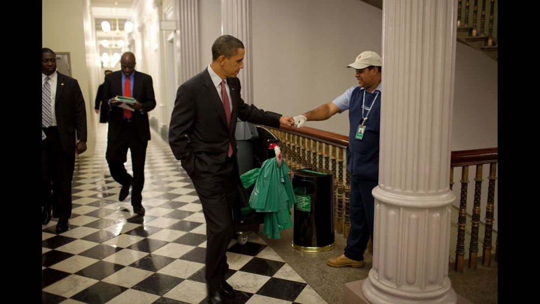The President fist-bumps custodian Lawrence Lipscomb in the Eisenhower Executive Office Building on December 3, 2009.