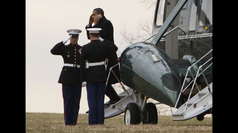 The President talks on a cell phone as he steps off Marine One in Baltimore on January 29, 2010.