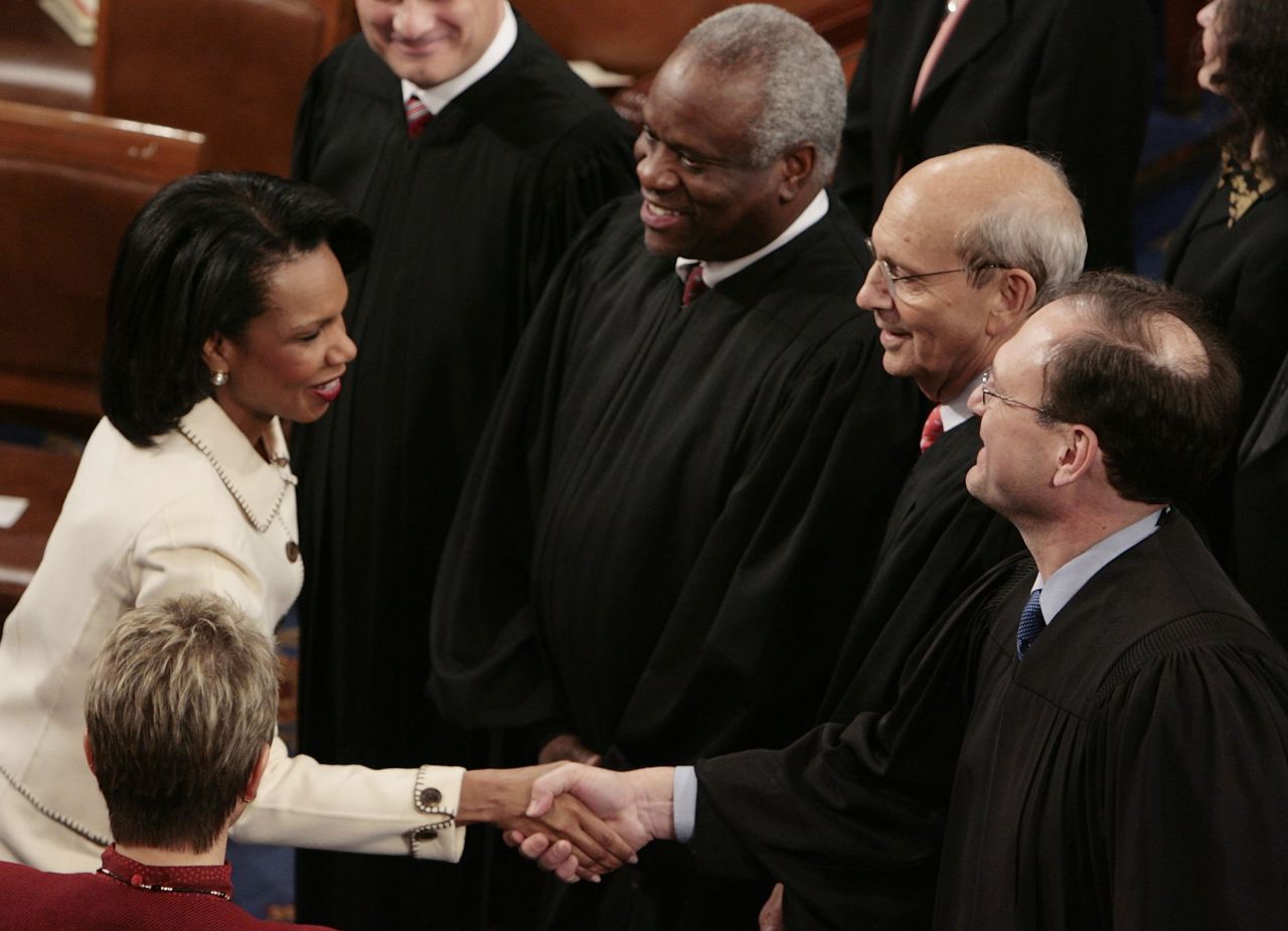 Thomas stands next to Supreme Court Justice Samuel Alito as Alito shakes hands with Secretary of State Condoleezza Rice prior to the State of the Union speech in January 2006.