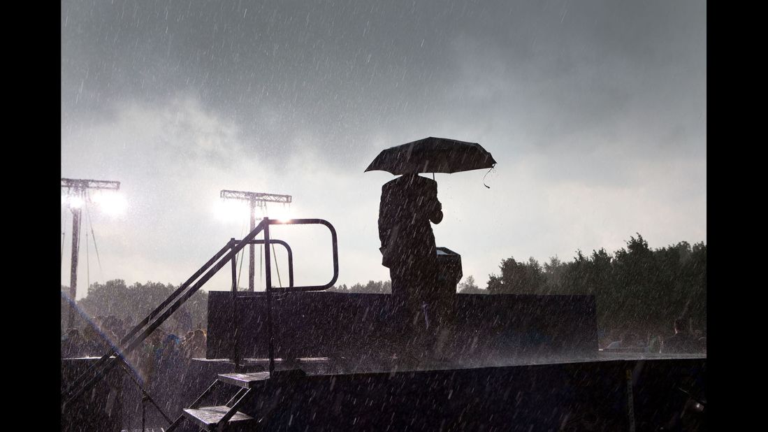 Obama takes the stage on a rainy day outside of Chicago on May 31, 2010. He was scheduled to give a Memorial Day speech. "When the lightning began, the Secret Service told the President that it was too dangerous to proceed," White House photographer Pete Souza said. "He took the stage by himself and informed the audience that his speech was canceled and that for everyone's safety, they should return to their buses. Later, he boarded a few of the buses to thank them for attending and apologized for not being able to speak."