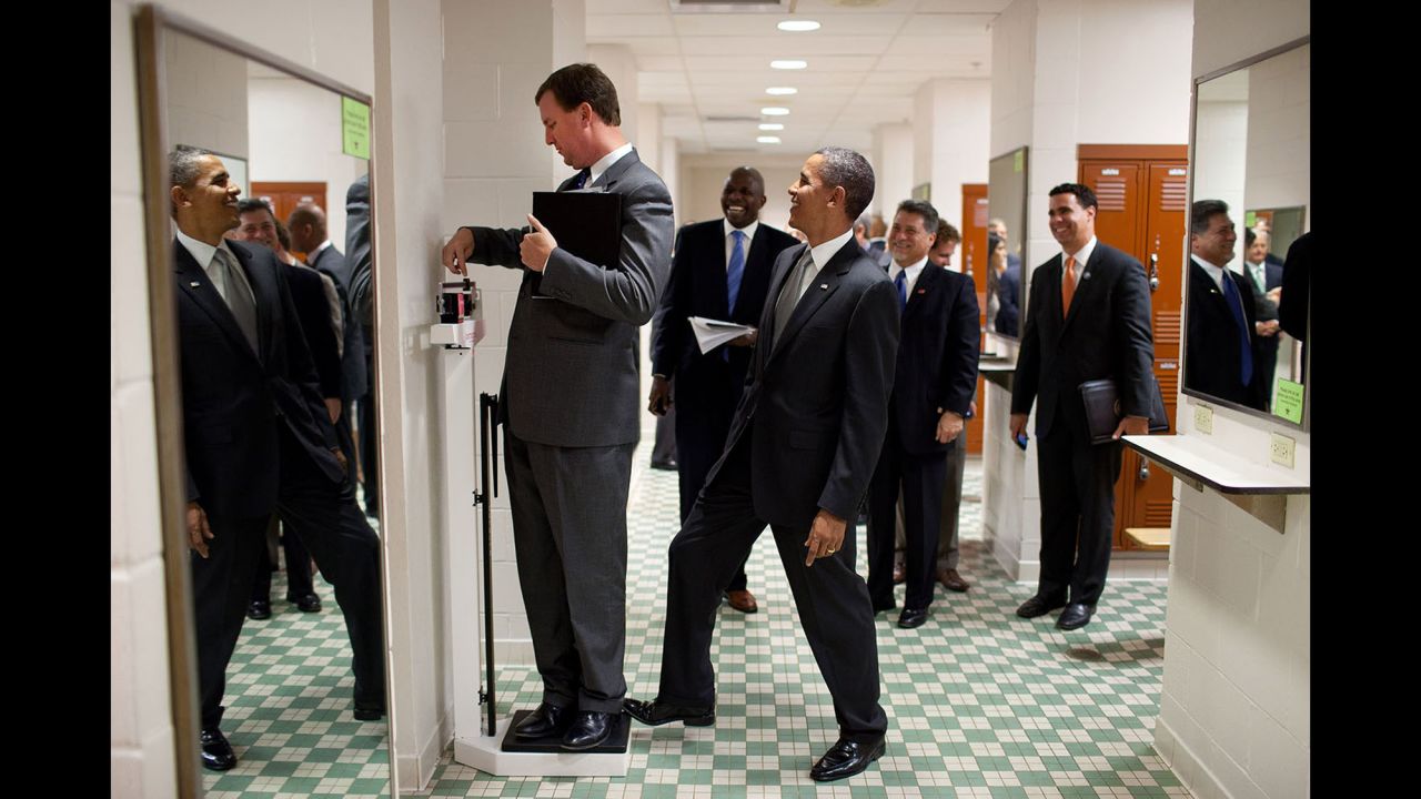 The President puts his toe on a scale as White House travel director Marvin Nicholson tries to weigh himself in Austin, Texas, on August 8, 2010.