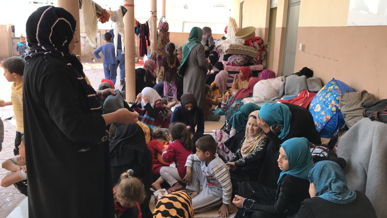 Women and children take shelter in a courtyard at Debaka Camp.