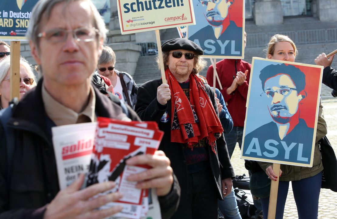 Demonstrators hold up a poster depicting Edward Snowden in a 2014 demonstration in Berlin, Germany.