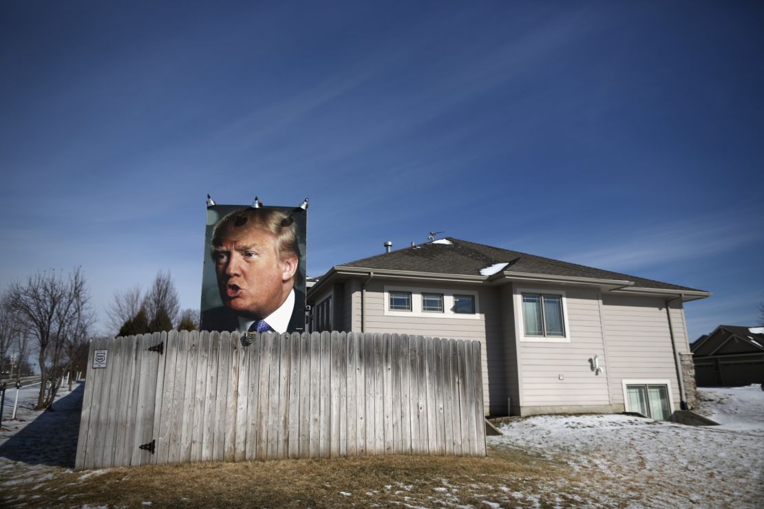  A giant poster of Republican presidential candidate Donald Trump stands in the backyard of a supporter in West Des Moines, Iowa.
