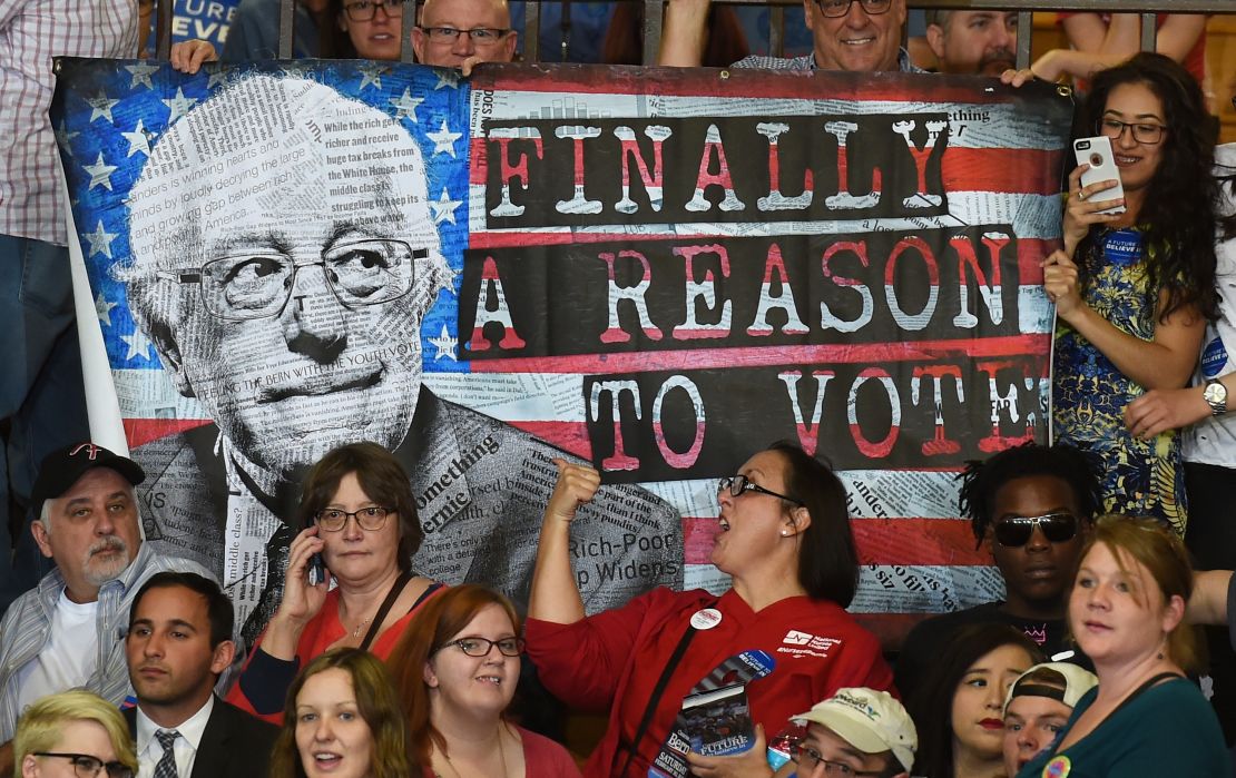 Supporters hold up a poster during a campaign rally by Bernie Sanders.