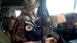 An Iraqi special forces soldier looks for danger as he drives to the front lines of Bartella. 