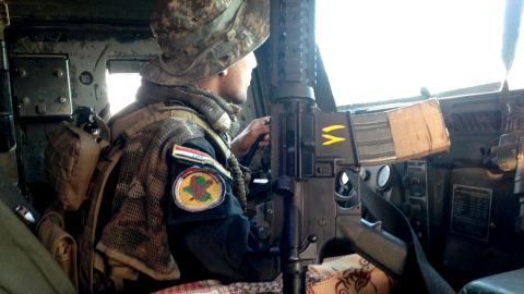 An Iraqi special forces soldier looks for danger as he drives to the front lines of Bartella.