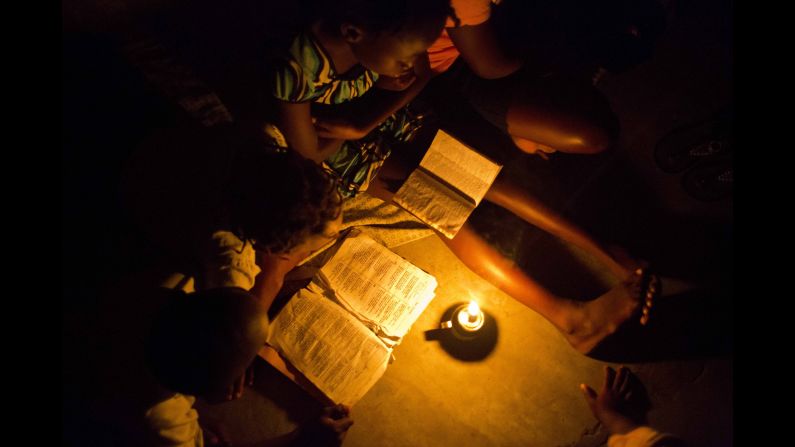 A 12-year-old girl reads the Bible in her school's classroom in Les Cayes, Haiti, on Sunday, October 16. She and other locals took refuge in the school after <a href="http://www.cnn.com/2016/10/03/world/gallery/hurricane-matthew/index.html" target="_blank">Hurricane Matthew</a> destroyed their homes in the village of Mersan. 