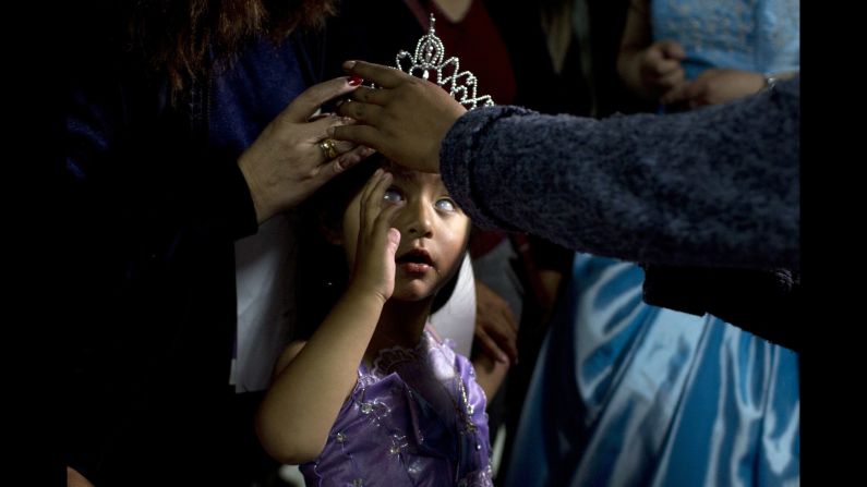 Mariela Flores, who is visually impaired, is crowned one of two Miss Jacha Uru ("Great Day") during a pageant in La Paz, Bolivia, on Friday, October 14. The pageant was organized by the families of people with disabilities. 