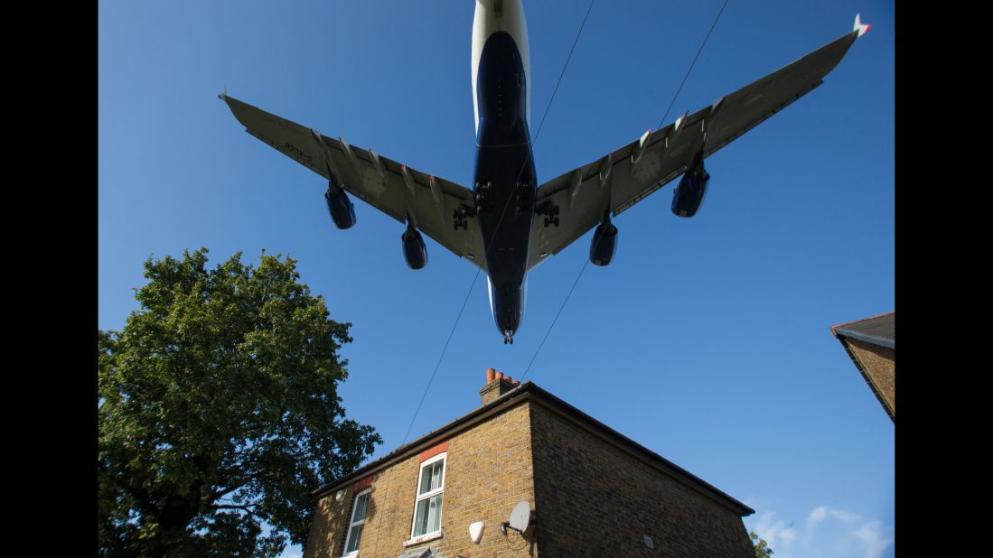 <strong>October 17:</strong> A passenger jet passes over a house as it prepares to land at London's Heathrow Airport.