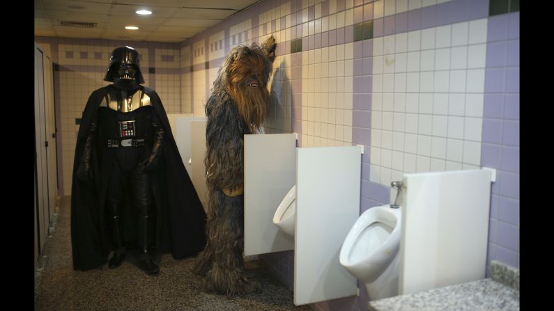 Fans dressed as "Star Wars" characters Darth Vader and Chewbacca use the bathroom during a film festival in Antalya, Turkey, on Monday, October 17.
