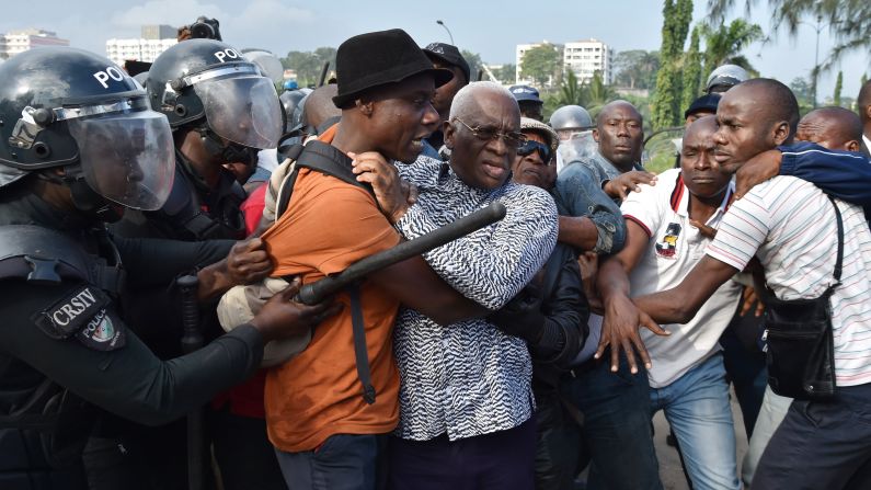Police in Abidjan, Ivory Coast, arrest opposition leader Aboudramane Sangare, at center with the glasses, during a protest over a new proposed constitution on Thursday, October 20.