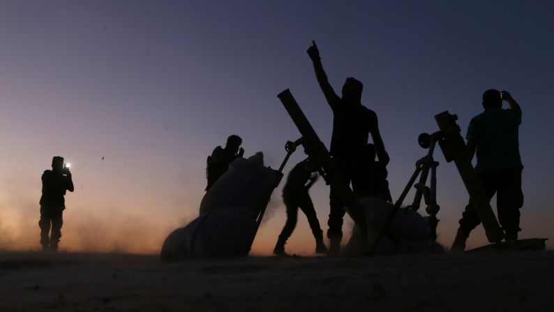 Fighters from the Free Syrian Army cheer as they battle ISIS on the outskirts of Dabiq, Syria, on Saturday, October 15.