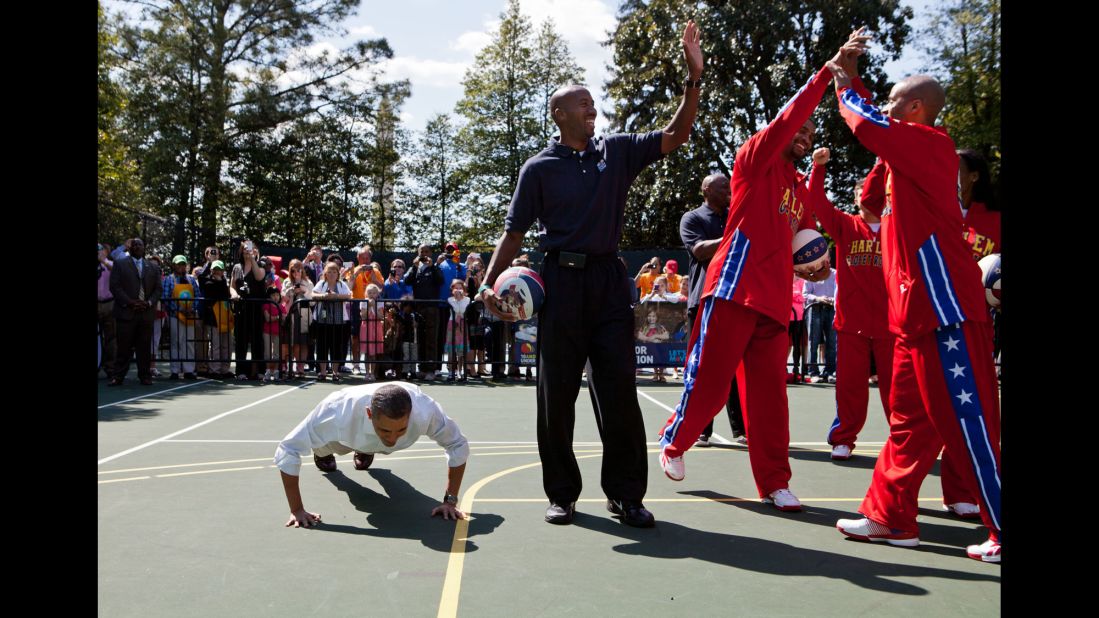 Obama does pushups on the White House basketball court after a member of the Harlem Globetrotters made a shot on April 9, 2012.