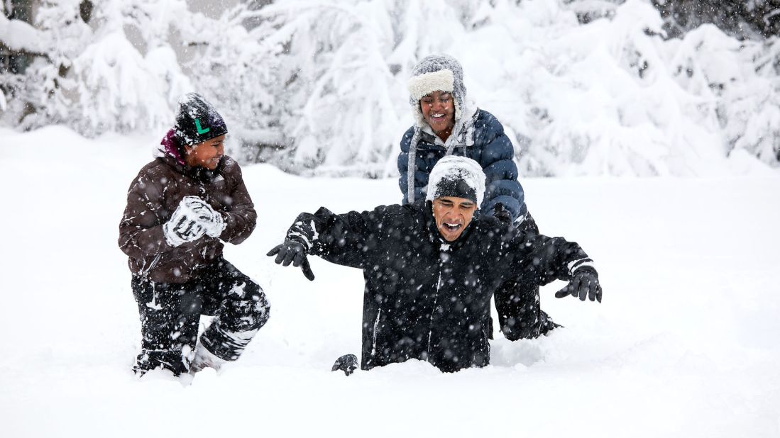 Obama plays with his daughters in the White House Rose Garden during a snowstorm on February 6, 2010.